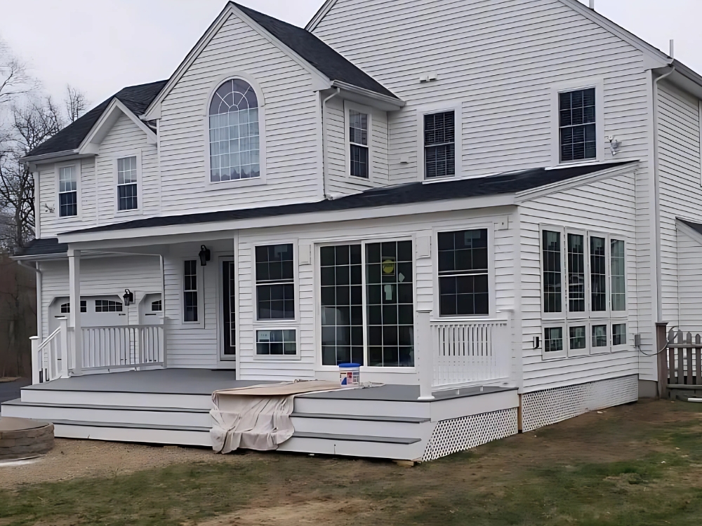 Completed sunroom and deck addition built by Lagace Construction to expand outdoor living space